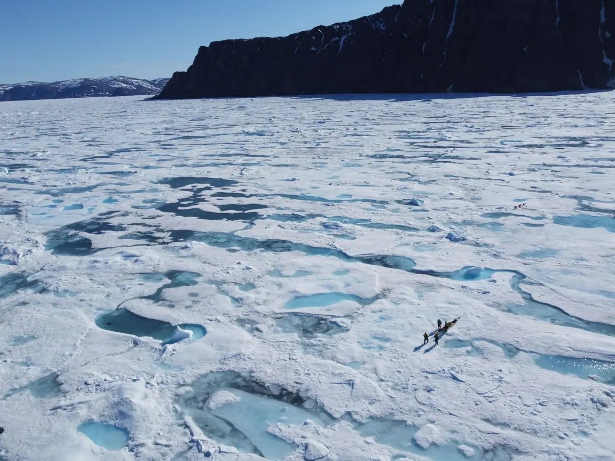 Aerial photograph of the Arctic Cowboys kayaks navigating broken sea ice on the Northwest Passage